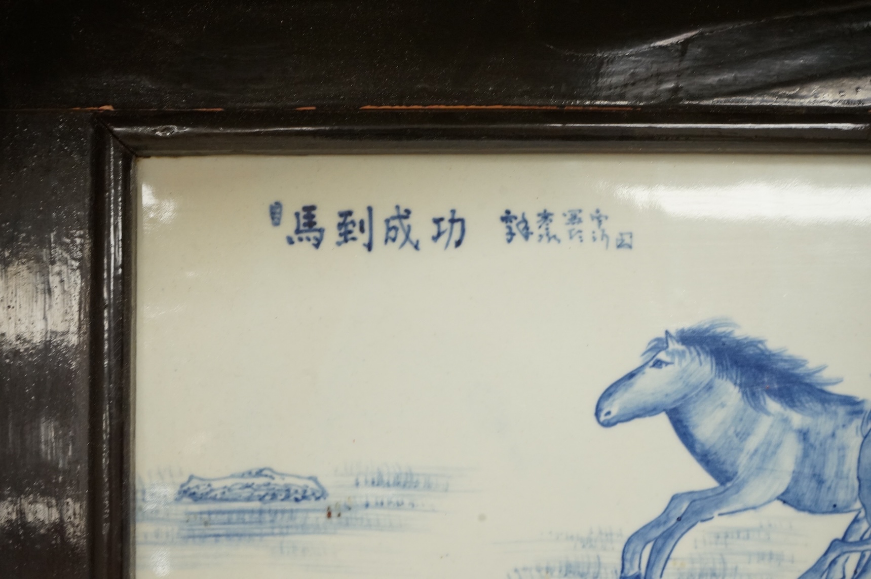 A Chinese framed blue and white porcelain panel depicting two horses, framed, overall 35 x 48cm